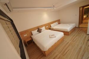 Postel nebo postele na pokoji v ubytování Southern Residency