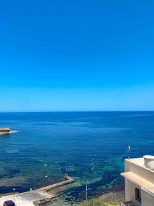 a view of the ocean from a building at Oyster Flats - Seaside Apartment 7 in Żebbuġ