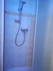a shower with a hose in a bathroom at Casa Giampy in Bergamo