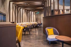 a row of tables and chairs in a restaurant at Dorint Airport-Hotel Zürich in Glattbrugg