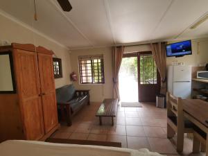 ein Wohnzimmer mit einem Sofa und einem Tisch in der Unterkunft Tourist Lodge Gansbaai in Gansbaai