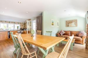 a kitchen and living room with a wooden table and chairs at Armando in Truro