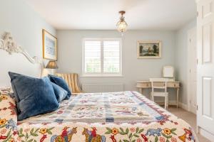 a bedroom with a bed with a quilt on it at Armando in Truro