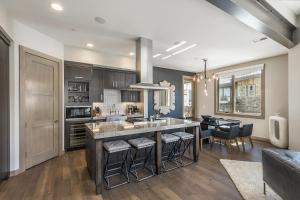 a kitchen with a large island with bar stools at Platinum Four Bedroom Suite apartment hotel in Park City