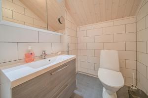 a bathroom with a toilet and a sink at Levillas Koutakaari 2B in Levi