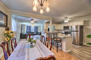 a kitchen and living room with a table and chairs at Convenient Jacksonville Home with Yard and Patio! in Jacksonville