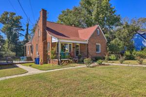 a brick house with a lawn in front of it at Convenient Jacksonville Home with Yard and Patio! in Jacksonville