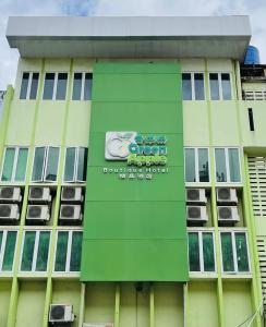 a green building with a sign on the side of it at Green Apple Boutique Hotel in Kota Kinabalu
