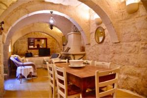 a kitchen and dining room with a table and chairs at Ta'Martin Farmhouse Xewkija Gozo in Xewkija