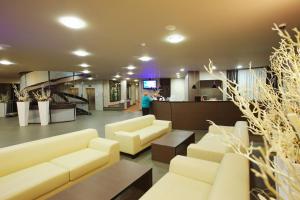a lobby with couches and tables and a staircase at Terme Olimia - Hotel Breza in Podčetrtek