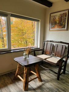 a room with a table and chairs and a window at Mountain apartment ''Michelle'' in Kakanj