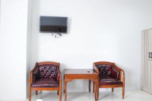 TV o dispositivi per l'intrattenimento presso Brahma Hotel Mitra RedDoorz