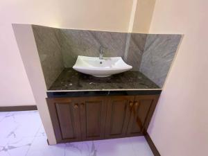 a bathroom with a white sink on a counter at Divine Resort Corporation in Moalboal
