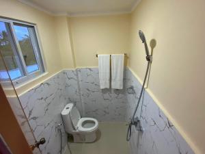a bathroom with a toilet and a shower at Divine Resort Corporation in Moalboal