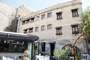 a large stone building with windows on the side of it at KALE EVİ BUTİK OTEL 