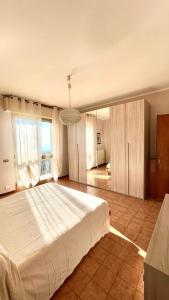 a bedroom with a large white bed in a room at Beatrice Apartment Crocello in Montignoso
