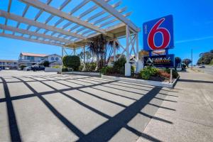 a gas station with a sign in front of it at Motel 6-Fort Bragg, CA in Fort Bragg