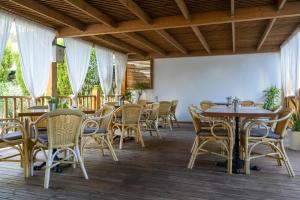 a restaurant with tables and chairs on a deck at Coral beach house & food in Playa de Palma