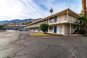 a hotel with a parking lot in front of it at Motel 6-Palm Springs, CA - East - Palm Canyon in Palm Springs