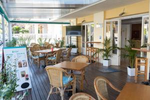 a restaurant with tables and chairs on a deck at Coral beach house & food in Playa de Palma +25 photos