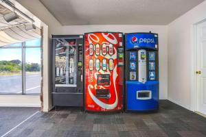 two soda machines are next to a gas pump at Motel 6-Fort Bragg, CA in Fort Bragg