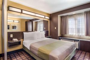 a hotel room with a large bed and a window at Motel 6-Canton, GA in Canton