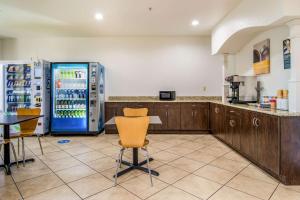 a kitchen with a refrigerator and a table and chairs at Motel 6-Canton, GA in Canton