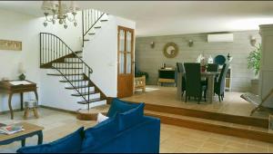 a living room with a staircase and a dining room at Gite correze spa jaccuzi massage in Saint-Germain-les-Vergnes