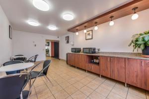 a cafeteria with a counter and a table and chairs at Motel 6-Saint Paul, MN - I-94 in Saint Paul