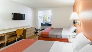 a hotel room with two beds and a desk at Motel 6-Medford, OR - North in Medford