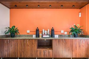 an orange room with a counter with bottles on it at Motel 6-Madison, WI - East in Madison