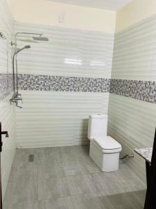 a bathroom with a toilet and a shower at Nziza View Hotel in Kigali