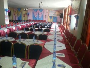 a row of tables and chairs in a banquet hall at Hotel Winstar in Eldoret