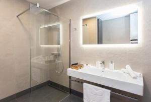 a bathroom with a sink and a shower at Complex Gallery Vitosha **** in Sofia +24 photos