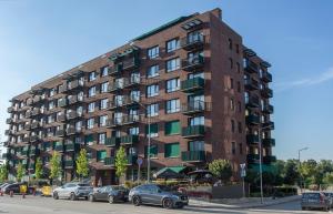 a large brick building with cars parked in front of it at Complex Gallery Vitosha **** in Sofia