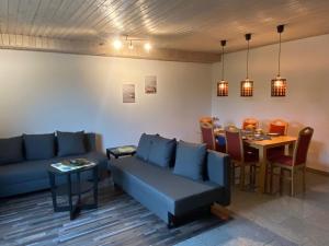 a living room with a couch and a table at Ferienwohnung Casa Herrmann in Losheim