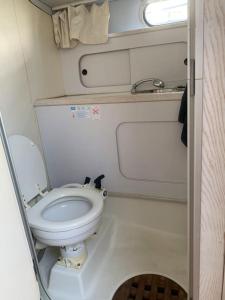a small bathroom with a toilet in an rv at Bateau à quai au Brusc, confort, coucher de soleil, calme in Six-Fours-les-Plages