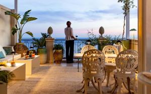 a man standing in front of a dining room table at Taodomus Small Boutique Hotel in Taormina