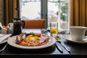 a plate of breakfast food on a table at Escape Boutique B&B in Llandudno