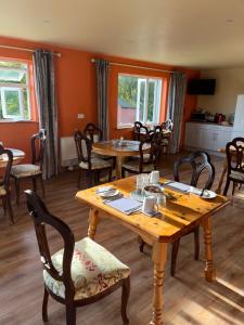 a dining room with wooden tables and chairs at Doughlasha House V93RX64 in Killarney