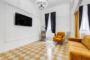 a living room with a couch and a chair at NEW!! SPAGNA Suite - Your Italian Holidays in Rome