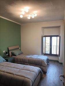 a bedroom with two beds and a ceiling fan at Vistalago in Gargnano