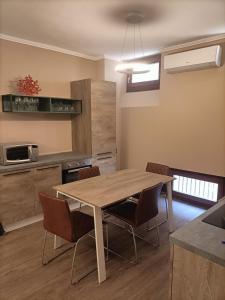 a kitchen with a table and chairs in a room at Vistalago in Gargnano