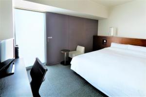 Ein Bett oder Betten in einem Zimmer der Unterkunft JR Inn Sapporo