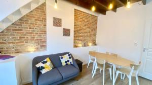 a living room with a couch and a table at Petite maison de pêcheur au coeur du Crotoy in Le Crotoy