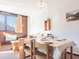 a kitchen with a table and chairs and a room with a window at Appartement Saint-Chaffrey , 1 pièce, 4 personnes - FR-1-330E-43 in Serre Chevalier