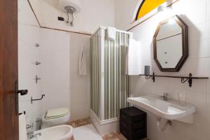 a bathroom with a sink and a toilet and a mirror at Tenuta Donna Vittoria - Mandarino in Trapani +20 photos