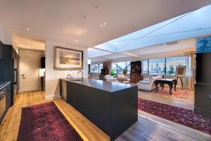 a kitchen and living room with a view of a living room at The Address - Luxury 3 Bedroom Penthouse Apartment in Napier