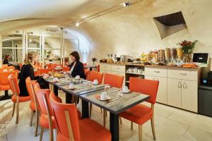 two women sitting at a table in a restaurant at Hôtel Le Relais Saint Charles in Paris +38 photos