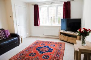 a living room with a couch and a television at College Court in Bedale